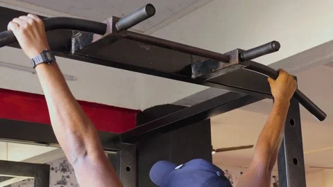 Close shot of an indian man exercising, doing pull-ups Stock Footage 147645020