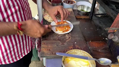 Close up shot of an Indian man making Vada paw in the streets of India Stock Footage 313022876