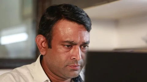 A Close up shot of an Indian man working in an office in New Delhi, India Stock Footage 259132633