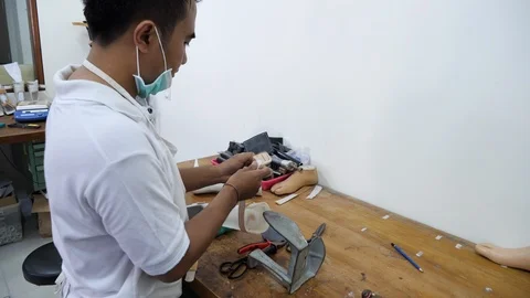 Close up shot of Indonesian man making prosthetic device, Bali Stock Footage 140260571