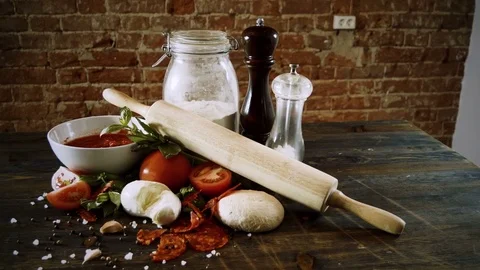 Close-up shot of ingredients for preparing a pizza on wooden table. 4K 库存影片 84785958