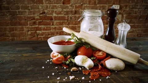Close-up shot of ingredients for preparing a pizza on wooden table. 4K 動画素材 84786084