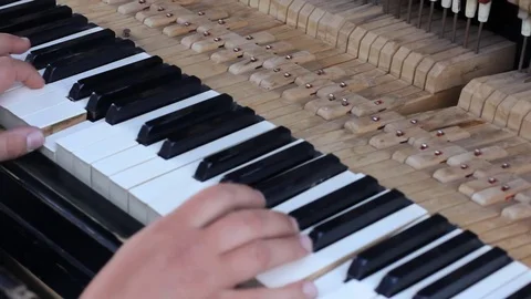 Close up shot of the inner workings of a grand piano. The hammers strike the Stock Footage 75647995