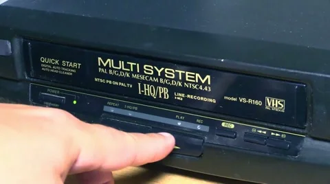 Close-up shot of inserting and removing a VHS videotape. Stock Footage 51132595