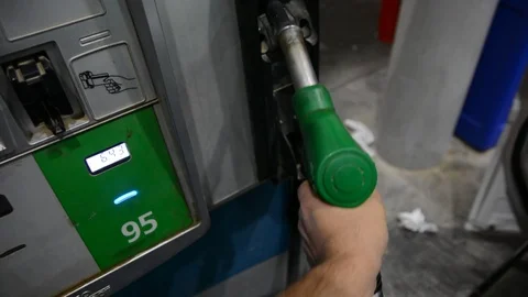 Close up shot of insertion of the nozzle and pumping gasoline into a white vehic Видео 94041803