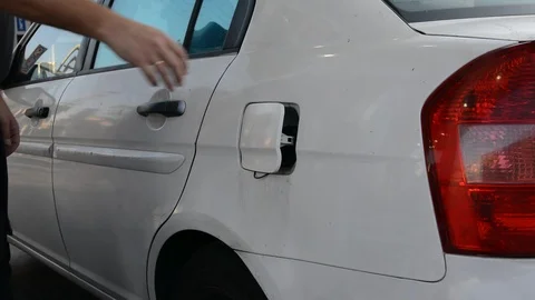 Close up shot of insertion of the nozzle and pumping gasoline into a white vehic Vidéo 94843685