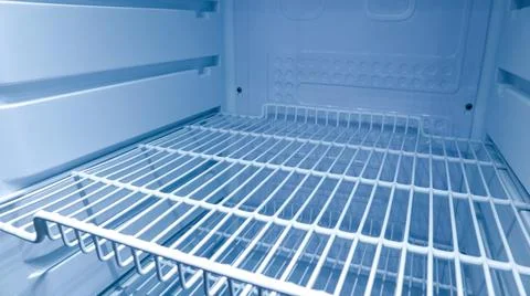 Close up shot inside a completely empty and clean refrigerator with white w.. Stock Photos