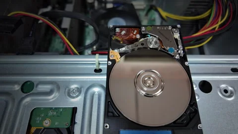 A close-up shot of the inside of a hard disk spinning to save data Stock Footage 342299277
