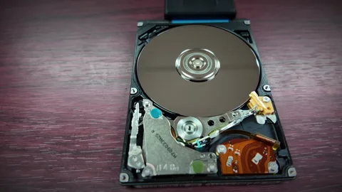 A close-up shot of the internal hard disk rotating to save data Stock Footage 342299199