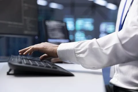 Close up shot of IT worker doing maintenance in servers farm 스톡 사진