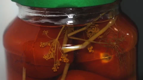 A close-up shot of a jar filled with pickled tomatoes Stock Footage 332224849