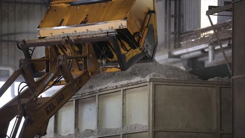Close up shot of JCB unload a cotton seeds into the cleaning machine. Stock Footage 313913421