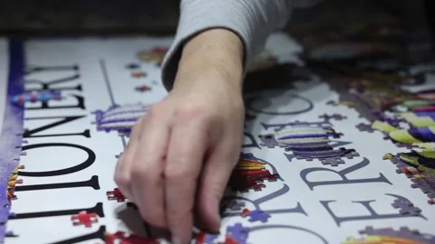Close-up shot of jigsaw pieces joining together to form part of the picture Stock Footage 294151816