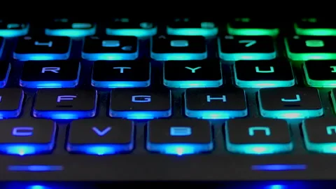 Close shot of keyboard with keys lighting in multi color light Stock Footage 145475247