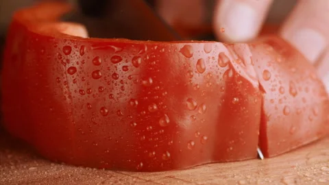 Close up shot of knife cutting re bell pepper in slow motion Stock Footage 152903264
