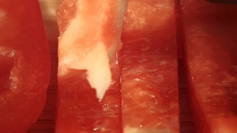 Close up shot of knife cutting red bell pepper. 4K macro trucking shot Stock Footage 118546539