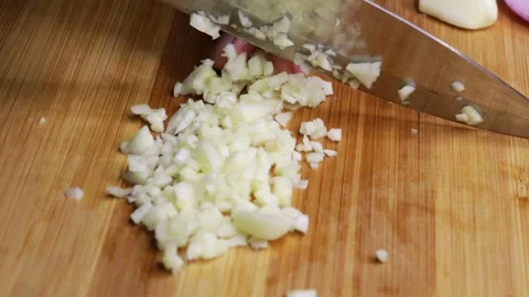 Close up shot of knife dicing the garlic cloves to small pieces. Stock Footage 298636918