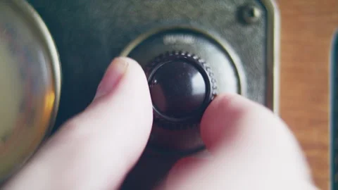 Close up shot of knob turning for changing volume on a vintage radio Stock Footage 273120878