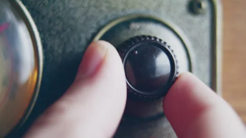 Close up shot of knob turning for changing volume on a vintage radio Stock Footage 273120880