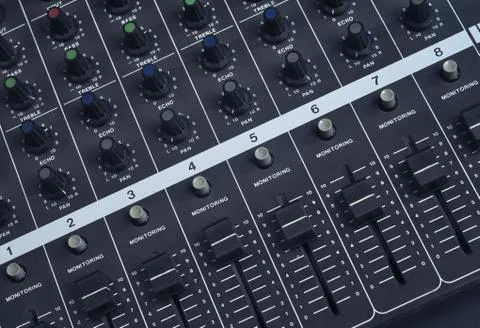 Close up shot at the knobs and faders of a vintage analog, studio music mixer Stock Photos