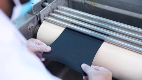 Close Up Shot Of A Lab Technician Testing Fabric For Compliance With Safety Stock Footage 334190003