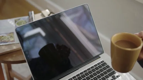 Close up shot of laptop screen with coffee out of focus in foreground Stock Footage 70809751