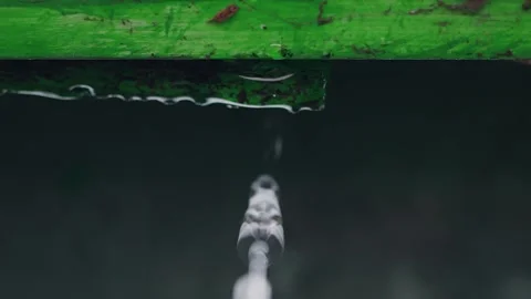 Close-up shot of large drops of rain fall down the pipes and roof Stock Footage 246959153