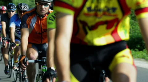 Close shot of large group of competing cycle racers on sunny day Stock Footage 32456395