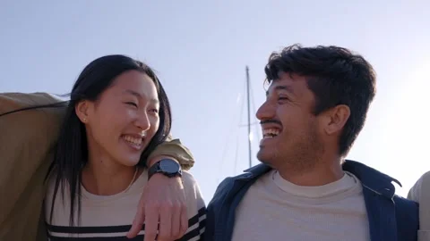 Close up shot of laughing group of multi-ethnic friends hugging in line smiling Stock Footage 256352993