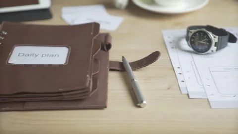 Close up shot of light brown leather note pad daily planner habit tracker bullet Stock Footage 137538687