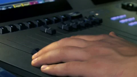 Close up shot of a lighting technician's hand operating light board Stock Footage 144430602