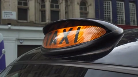 A close up shot of a London Black cab orange Taxi signal sign Stock Footage 132811403