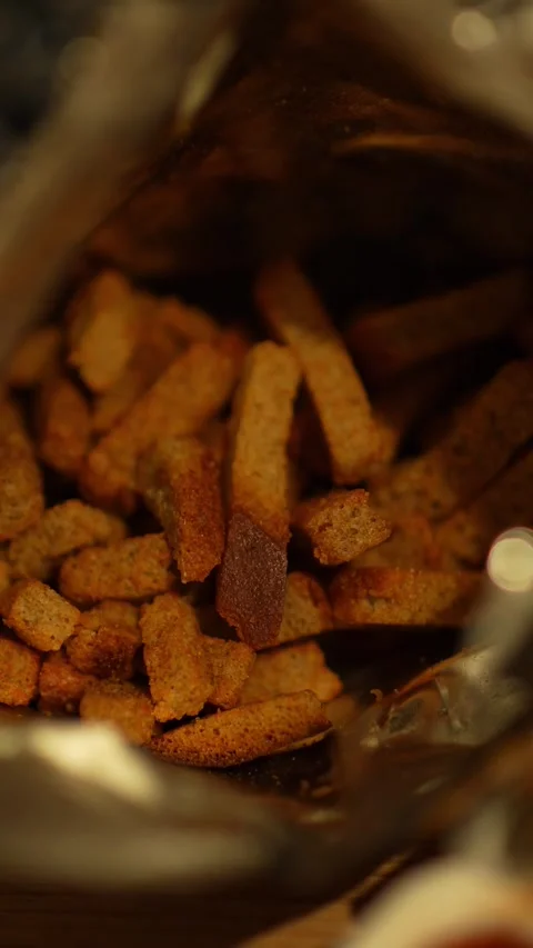 A close-up shot looking inside an open foil bag of crunchy rye croutons 스톡 동영상 344884283