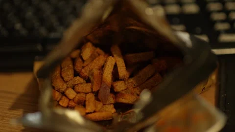 A close-up shot looking inside an open foil bag of crunchy rye croutons 스톡 동영상 344884288