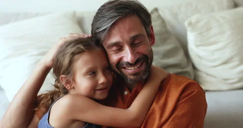 Close up shot loving dad cuddling little 6s daughter Video stock 260606571