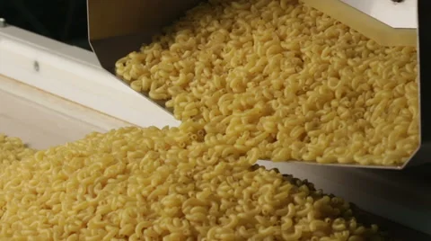 Close up shot of macaroni dropping from a machinery to prepare pasta 库存影片 61277973