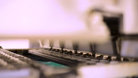 Close up shot of machine funnelling batter into small cases at high speed Stock Footage 108758707