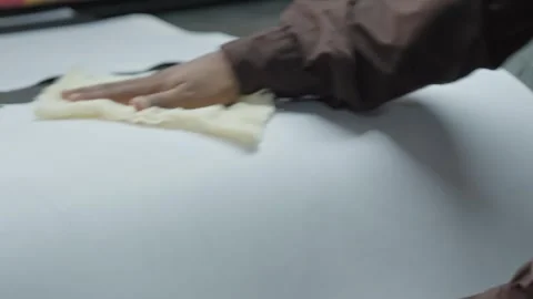 Close Up Shot Of A Machine Operator Cleaning Animal Hides And Placing Them On Video stock 295937348