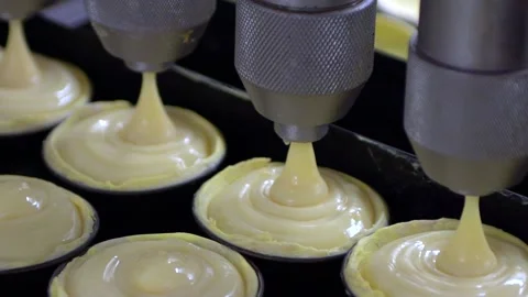 Close shot of machine Pouring cream to the Typical Portuguese Egg Tart at Pas Stock-Footage 187061824