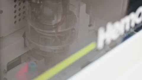 Close shot of a machine unscrewing a cap from a test tube in an autmated lab Stock Footage 232489534