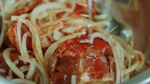 Close up shot in macro of adding oil to meat with onion and red pepper to Video stock 104127210