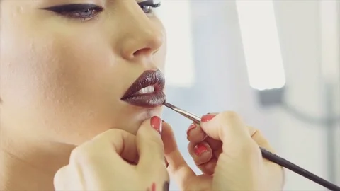 Close up shot of the make-up artist's hand, who applies make-up on the face Video stock 84590442