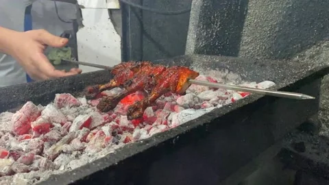 Close up shot of making of Chicken Tangri Kabab in road side stall in Stock Footage 237735351
