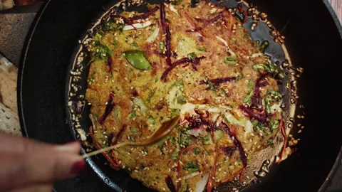 Close up shot of making chilla in a frying pan garnish with beetroot. Stock Footage 282766705