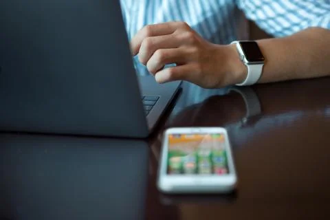 Close-up shot of male code developer hands typing, working behind office table Stock Photos