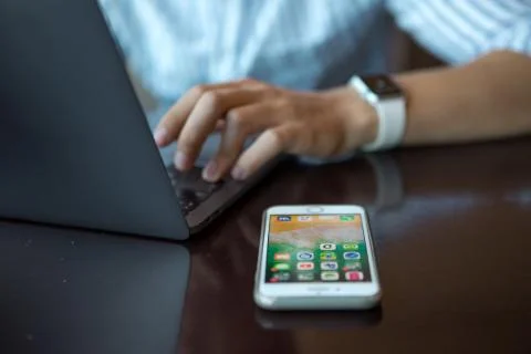 Close-up shot of male code developer hands typing, working behind office table Stock Photos