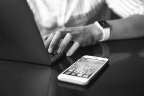 Close-up shot of male code developer hands typing, working behind office table Stock Photos
