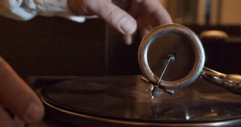 Close-up shot of a man changing a vinyl record side in a vintage gramophone. Stock Footage 98614691