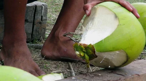 Close up shot of a man chopping coconut with a knife Stock Footage 40690166