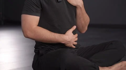 Close-up shot of a man demonstrating proper breathing techniques for enhancing Stock Footage 264305052